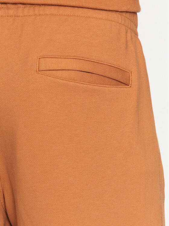 New Balance New Balance Spodnie dresowe MP23551 Pomarańczowy Relaxed Fit