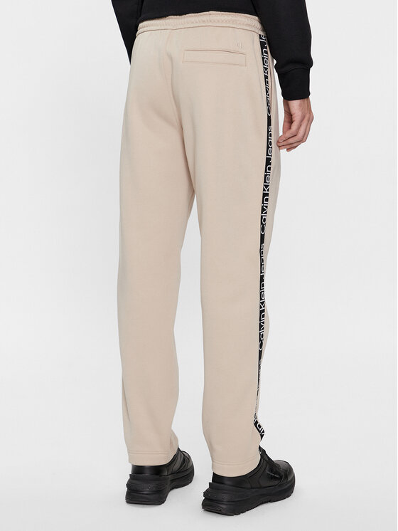 Calvin Klein Jeans Calvin Klein Jeans Spodnie dresowe Logo Tape J30J324376 Beżowy Relaxed Fit