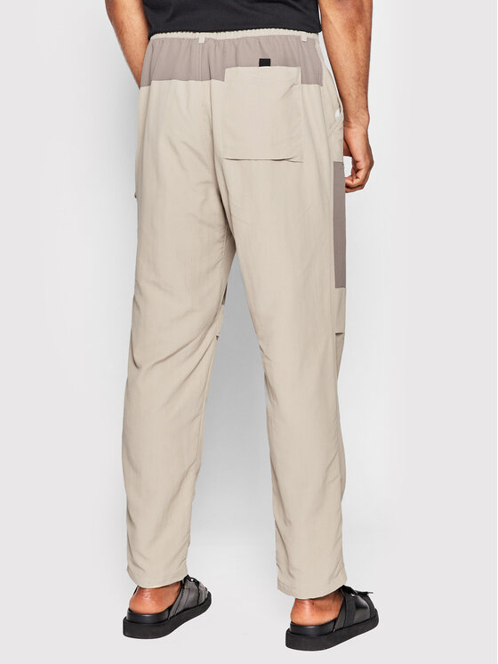 New Balance New Balance Pantaloni din material MP21502 Bej Relaxed Fit