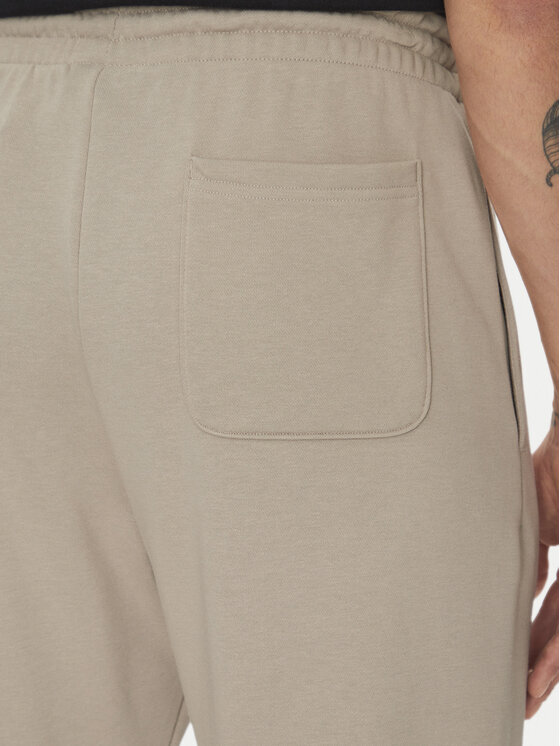 New Balance New Balance Spodnji del trenirke Essentials MP41519 Bež Relaxed Fit
