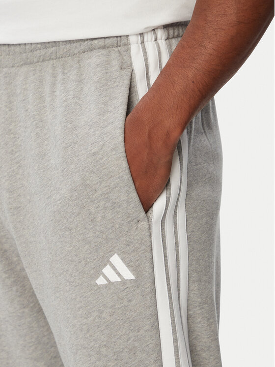 adidas adidas Dressipüksid Essentials 3-Stripes KY4195 Helehall Regular Fit