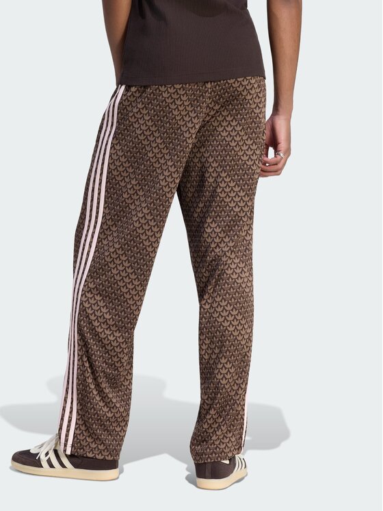 adidas adidas Spodnie dresowe Firebird loose monogram Brązowy ciemny Regular Fit