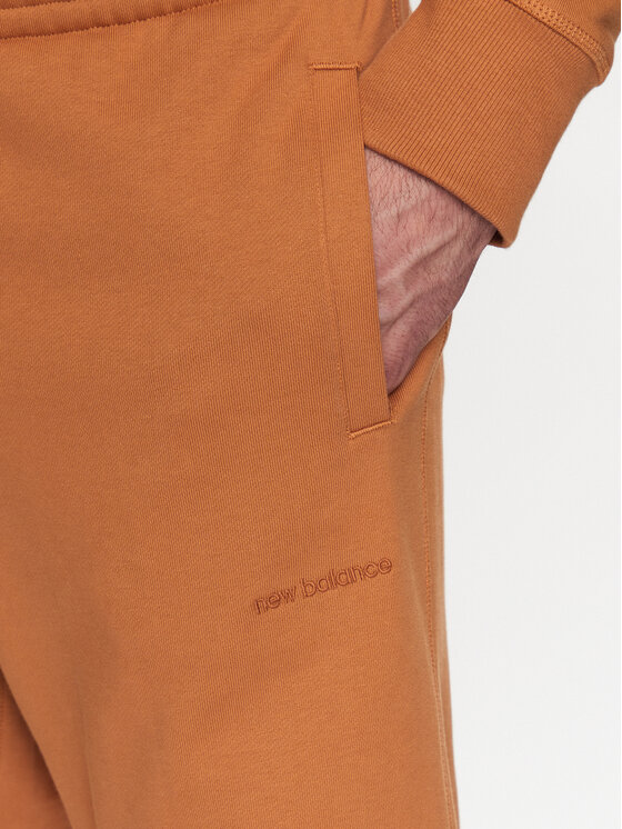 New Balance New Balance Spodnie dresowe MP23551 Pomarańczowy Relaxed Fit