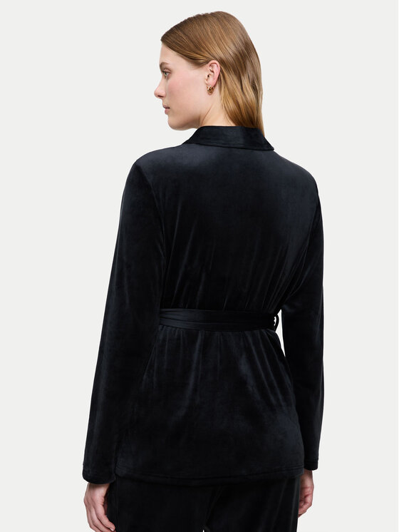 Modelka w bluzie z paskiem, widok na sylwetkę od tyłu.