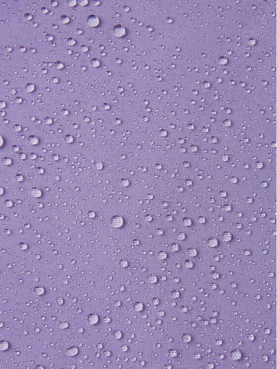 Zbliżenie na powierzchnię materiału kurtki z kroplami wody.